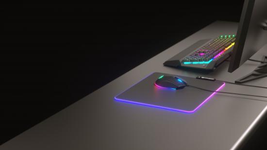 Moderne Gaming-Station mit RGB-beleuchteter Maus, Mauspad und Tastatur auf einem Schreibtisch